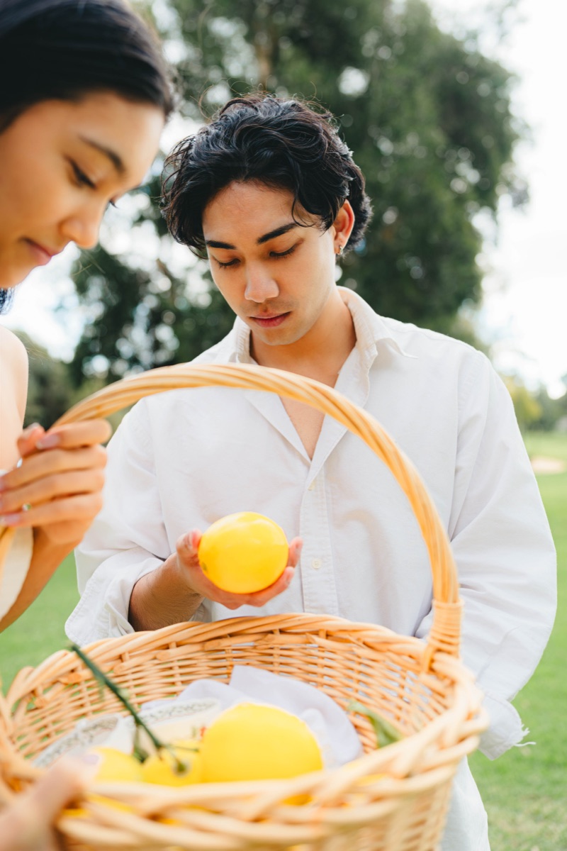 Picnic portrait with a lemon basket in soft garden light