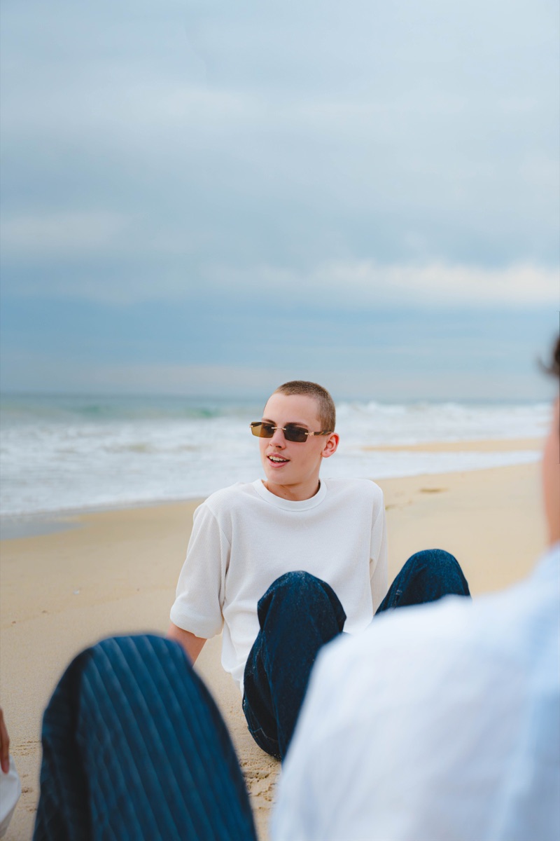 Beach portrait with a model seated in the sand