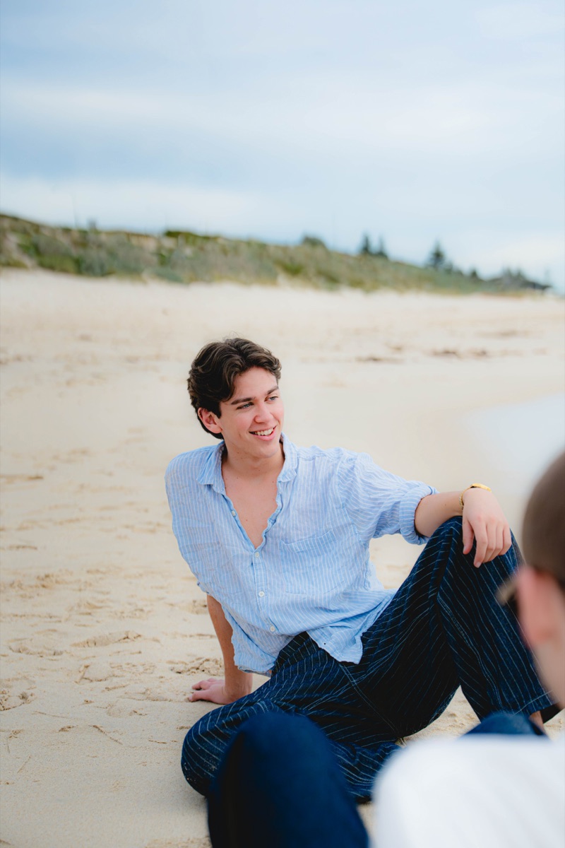 Beach portrait of a man in a blue striped shirt